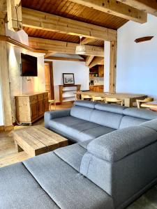 a living room with a couch and a table at Exclusive Chalet Val Thorens Center by GlobalSki in Val Thorens