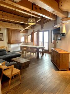 a living room with a table and a dining room at Exclusive Chalet Val Thorens Center by GlobalSki in Val Thorens