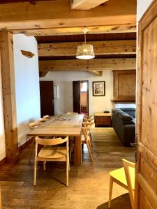 a dining room with a wooden table and chairs at Exclusive Chalet Val Thorens Center by GlobalSki in Val Thorens