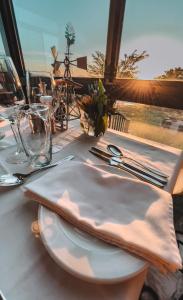 a white plate on a table with a view of the ocean at De Zeekoe Guest Farm in Oudtshoorn