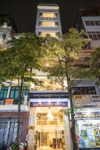 a store with trees in front of a building at Hotel No 9 Nguyễn Trường Tộ - by Bay Luxury in Hanoi