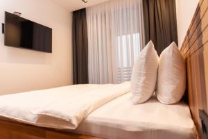 a hotel room with a bed with two pillows at Aparthotel Poljice in Jahorina