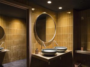 a bathroom with two sinks and a mirror at Yurbban Trafalgar Hotel in Barcelona