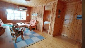 a living room with a table and chairs in a room at Messlingen, Sjövägen 5 in Funäsdalen