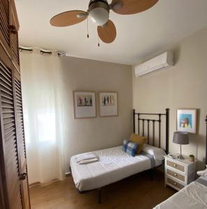 a bedroom with a bed and a ceiling fan at Apartamento Plaza Grande in Zafra