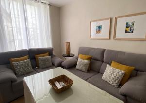 a living room with a couch and a table at Apartamento Plaza Grande in Zafra