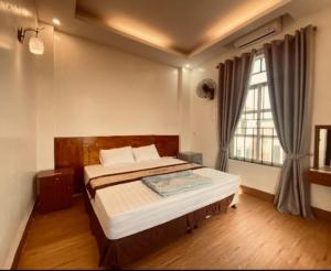 a bedroom with a bed and a large window at Hương Sen Hotel Bac Giang in Bắc Giang