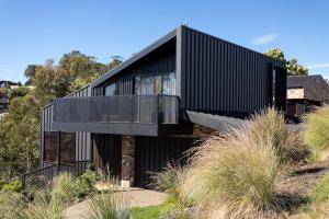 a house with a black facade at Haven in the Heights - Luxe Design & Sprawling Views in Inveresk