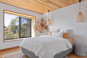 a bedroom with a large bed and a window at Haven in the Heights - Luxe Design & Sprawling Views in Inveresk