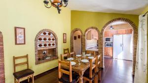 a kitchen and dining room with a table and chairs at Casa Herrero El Borge by Ruralidays in Almáchar