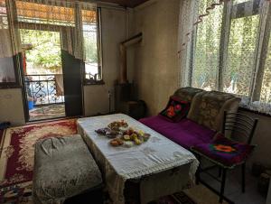 a living room with a table and a couch at Guest house Muslim 