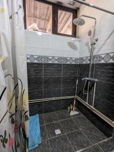 a bathroom with a shower with a window at Guest house Muslim 