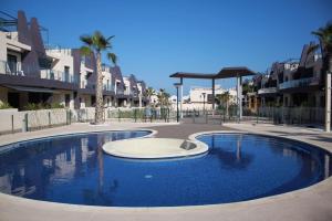 a large swimming pool in front of some buildings at COSTA ELISA20 MIL PALMERAS in La Horadada