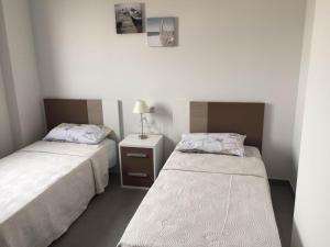 a bedroom with two beds and a lamp on a table at la mata aqua nature in La Mata +95 photos