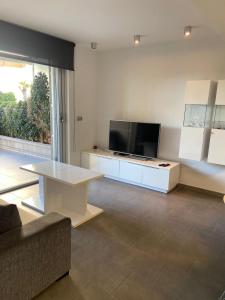a living room with a tv and a couch and a table at la mata aqua nature in La Mata