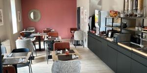 a restaurant with a counter and tables and chairs at Saint Jean in Wimereux