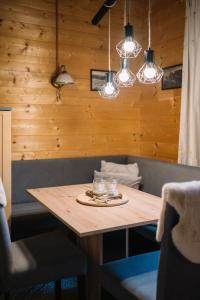 a dining room table with glasses and lights at Steinnock Chalet in Bad Kleinkirchheim