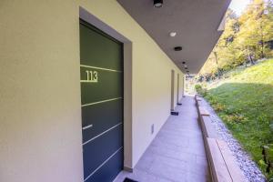 a hallway of a building with a green door at Penzion Šterk in Most na Soči