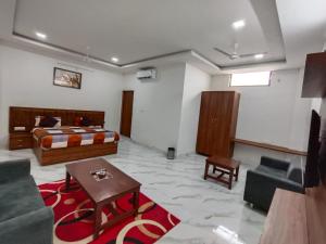 a hotel room with a bed and a living room at Bachan Niwas Hotel in Jodhpur