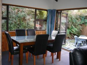a dining room with a table and chairs at Central & Relaxing in Franz Josef