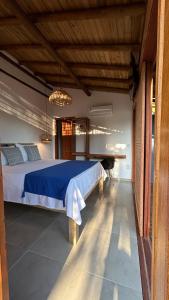 a bedroom with a large bed and a pool table at Taipu Loft - Península de Maraú in Marau