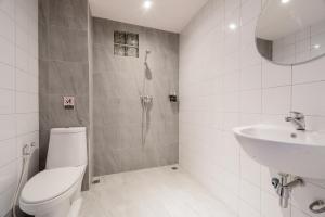 a bathroom with a shower and a toilet and a sink at Moon Budget Hotel in Ao Nang Beach