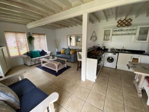 a living room with a couch and a kitchen at The Dunes Resort 80 & 69 in Plettenberg Bay