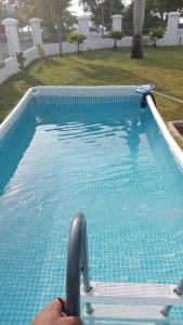 a person is going down a swimming pool at The Beach House @ Kuantan in Kuantan