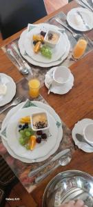 a wooden table with plates of food on it at 6 Olives B&B in Darling