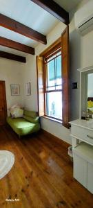 a room with a bed and a window and a mirror at 6 Olives B&B in Darling