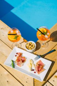 a plate of food on a table with two glasses at Penzion Šterk in Most na Soči