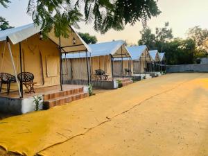 a row of tents with tables and chairs on a road at K's Villa Bella in Bhuj