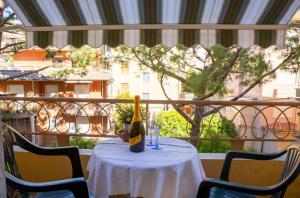 - une bouteille de vin assise sur une table sur un balcon dans l'établissement Bilocale Imperatrice, à Sanremo