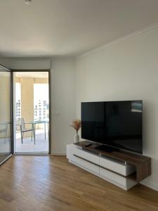 a living room with a large flat screen tv at Le Raphaël - Sur les hauteurs de Bordeaux in Bordeaux