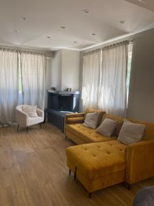 - un salon avec un canapé et une chaise dans l'établissement Villa Sama’, à Roccaraso