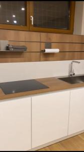 a kitchen with white cabinets and a sink at Villa Sama’ in Roccaraso