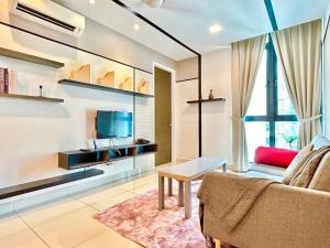a living room with a couch and a table and a tv at Comfort Place 1-8 Pax 3Q beds Ara Damansara Center in Petaling Jaya