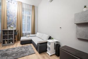 a living room with a couch and a table at Petite Elegance Apartment in Budapest