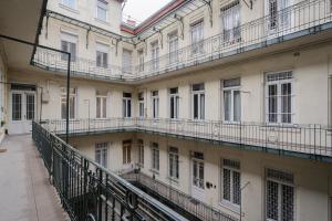 an empty courtyard of a building with balconies at Petite Elegance Apartment in Budapest