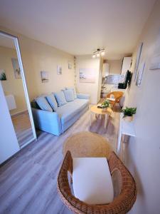 a living room with a couch and a table at Studio 1 piece vacances proche de la mer in Le Grau-du-Roi