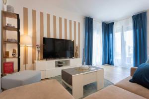 a living room with a couch and a tv at Luxury & Elegance 2BDR Apartment in Zagreb