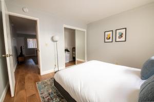 a white bedroom with a bed and a hallway at Santa Clara 2br w wd nr caltrain station SFO-1524 in Santa Clara