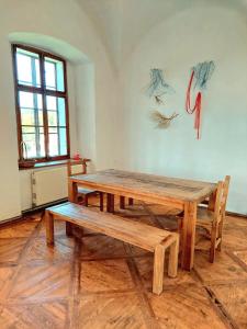two wooden tables and benches in a room at Stylish Getaway at Austrian Renaissance Castle 
