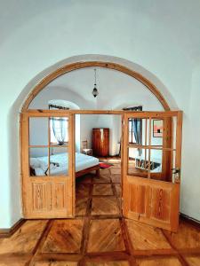 a bedroom with a bed and an arched doorway at Stylish Getaway at Austrian Renaissance Castle 