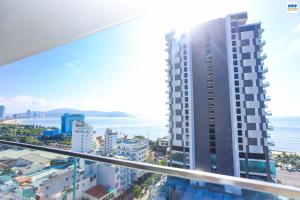 a view of a tall building with the ocean in the background at FLC Sea Tower Quy Nhon - Căn Hộ View Biển in Quy Nhon