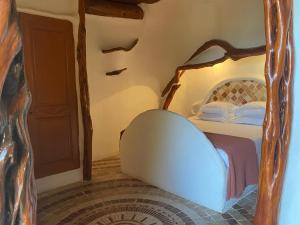 a bedroom with a bed with a wooden frame at Domaine de Piscia in Figari