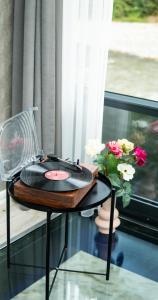 a table with a record player on it next to a window at River Side TinyHouse in Çamlıhemşin