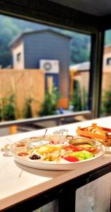 a plate of food sitting on top of a table at River Side TinyHouse in Çamlıhemşin