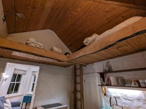 a room with a ceiling with wooden ceilings at The Lookout: Cosy Compact Cottage in Totland
