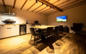 a kitchen and dining room with a table and chairs at Luxury Aframe in Râşnov